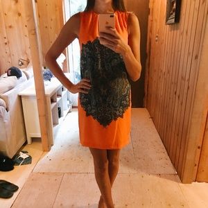 Orange and patterned shift dress.